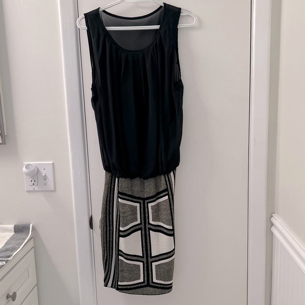 Medium length black dress.